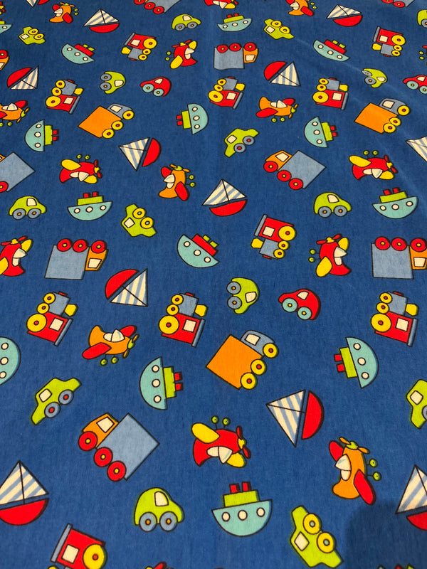 Planes, trains and cars flannel.   Royal blue background with planes, trains , cars and boats in primary colors.  100% cotton, 44” wide and $4.99 per yd.