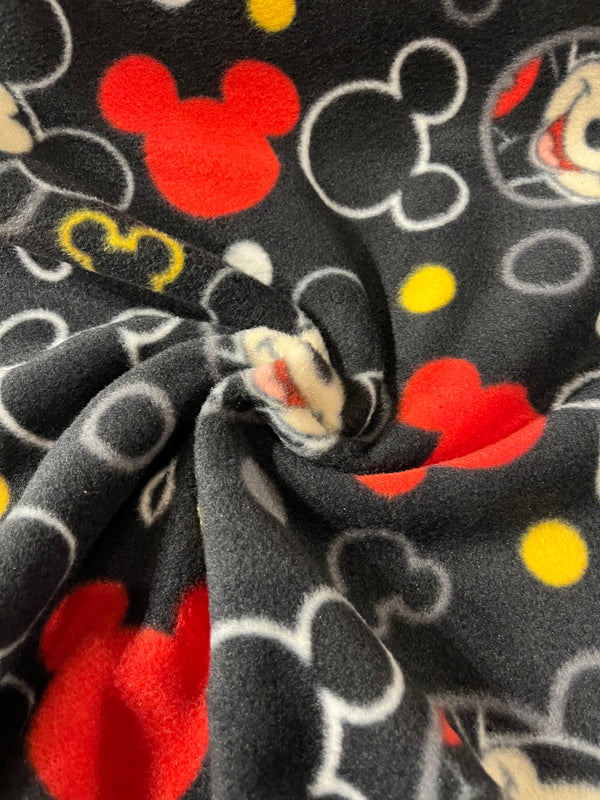 Mickey on black background.  58” wide, 100% polyester fleece and $6.99 per yd.