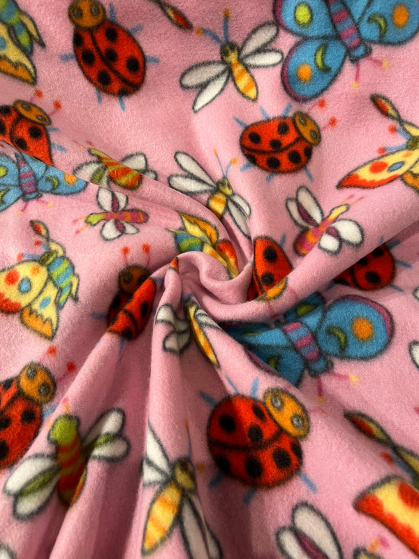 Lady bugs, fireflies and butterflies on pink background.  58” wide, 100% polyester fleece, and $6.99 per yd.