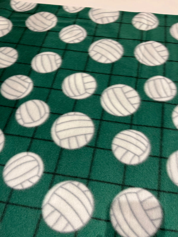 Volleyball fleece-white volleyballs on dark green background.  58” wide, 100% polyester and $6.99 per yd.