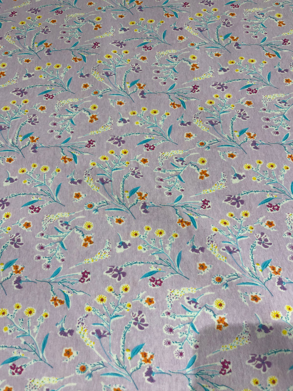 Floral flannel-lavender background with yellow, purple and orange flowers on a teal stem.  100% cotton, 44” wide and $4.99 per yard.
