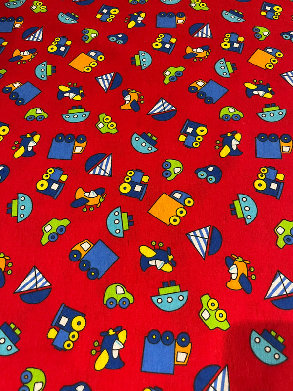 Planes, trains and car flannel.  Red background with planes, trains, cars and boats in primary colors.   100% cotton, 44” wide and $4.99 per yd.