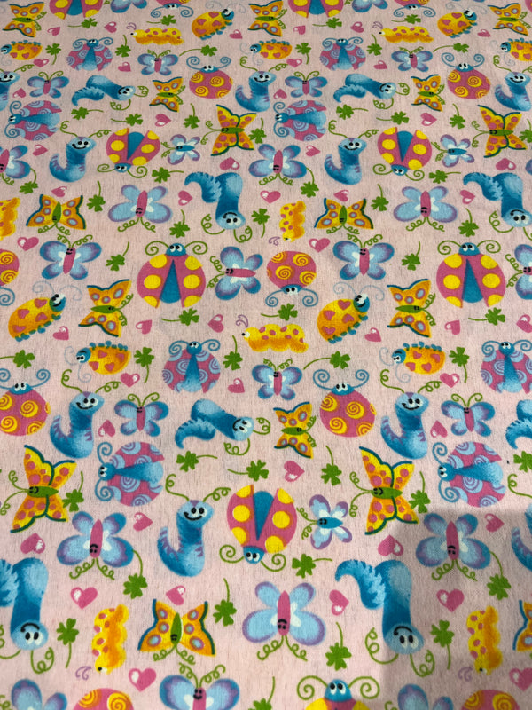 Bugs and butterflies flannel.  Light pink background with brightly colored bugs and butterflies.  100% cotton, 44” wide and $4.99 per yd