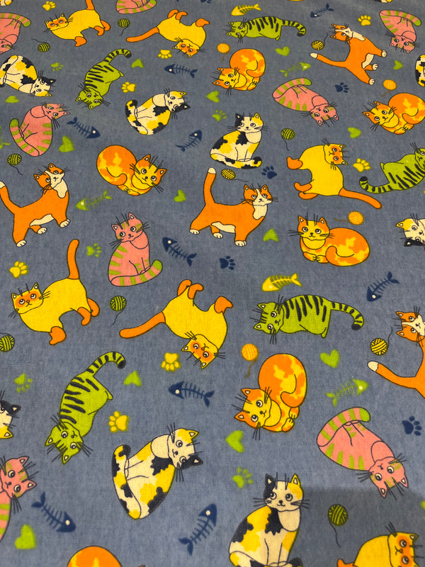 Cat flannel. Cornflower blue flannel multi colored cats.    100% cotton, 44” wide and $4.99 per yd.