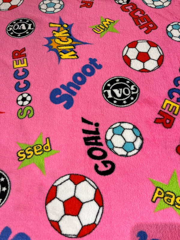 Hot pink soccer themed whisper fleece.   60” wide, 100% polyester and $9.99 per yd