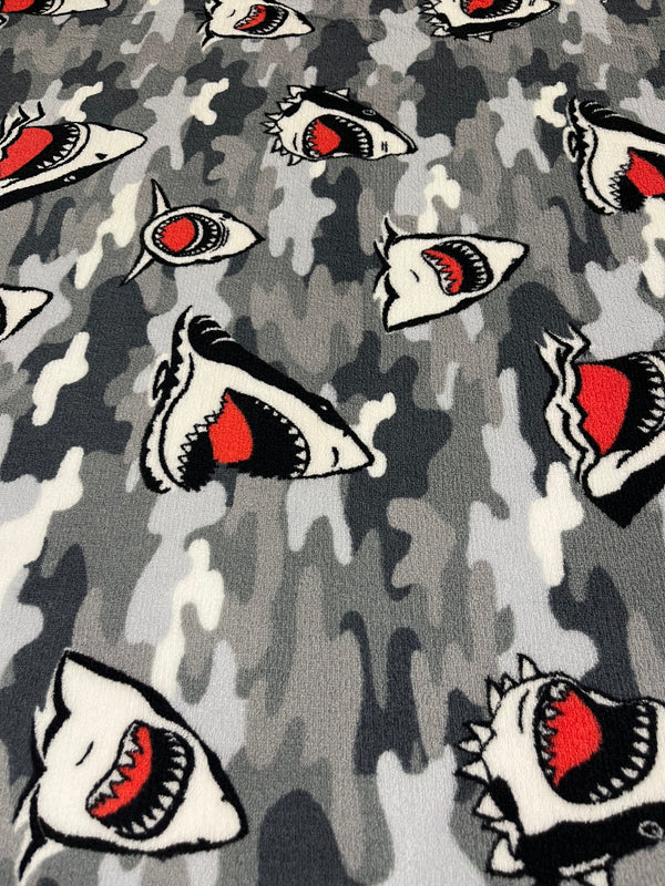 Shark attack whisper fleece.    Black and white sharks on grey background.  100% polyester, 60” wide and $9.99 per yd.