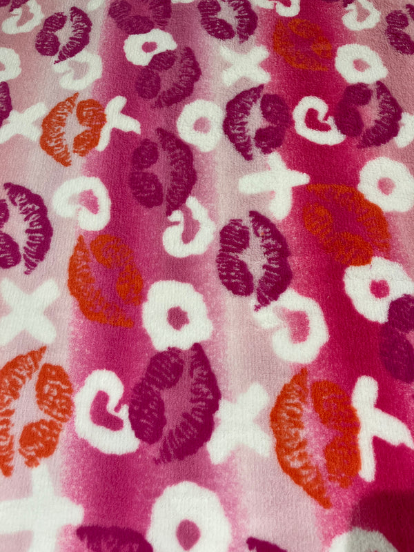 Hugs and kisses whisper fleece.    Pink and red themed x’s & o’s.   100% polyester, 60” wide and $9.99 per yd.