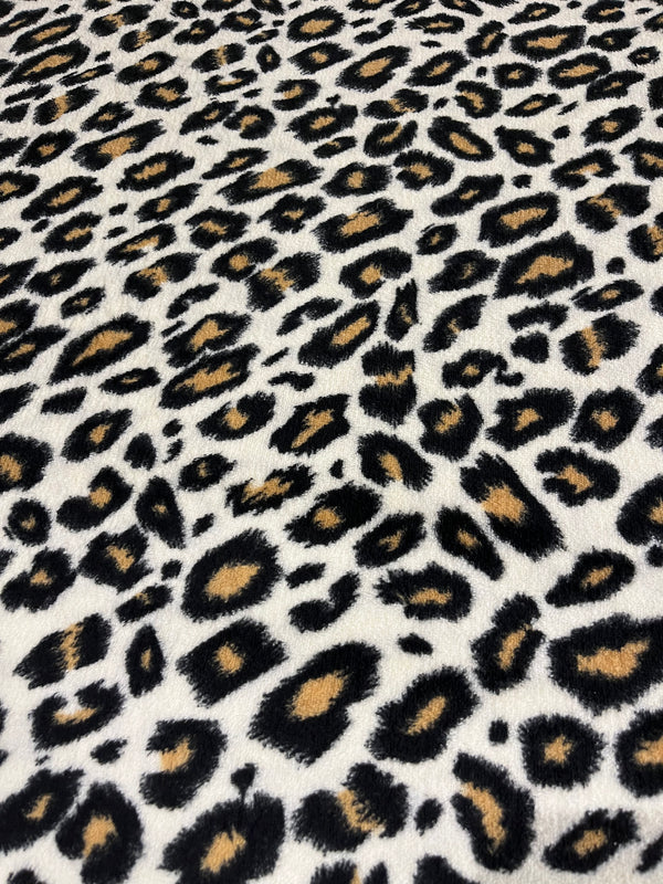 Animal print whisper fleece.   Black and brown spots on cream background.  100% polyester, 60” wide and $9.99 per yd.