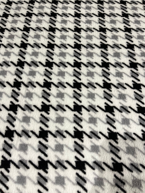 Herringbone pattern whisper fleece.   Grey and black on white background.  100% polyester, 60” wide and $9.99 per yd.