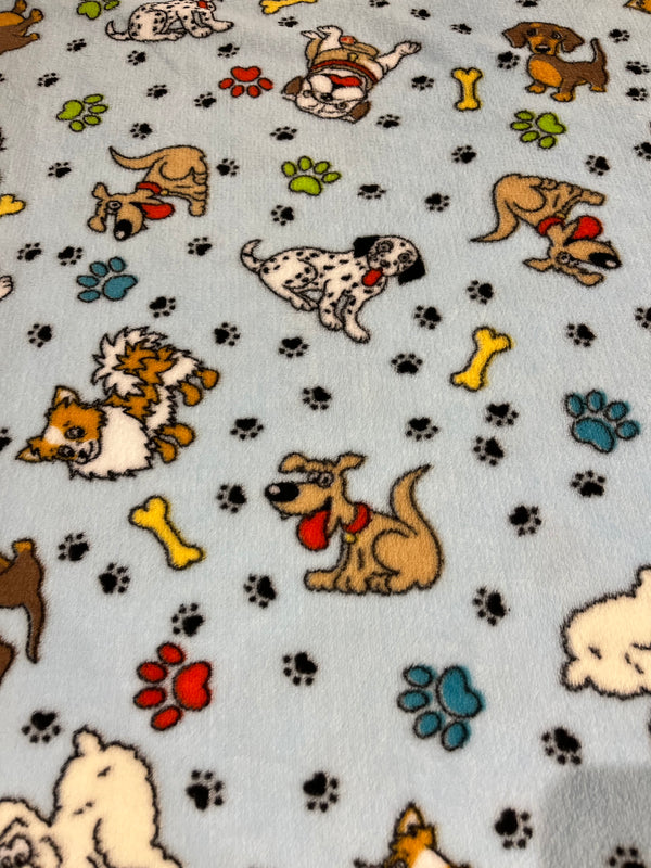 Dog world whisper fleece.  Playful dogs on light blue background.  100% polyester, 60” wide  and $9.99 per yd.