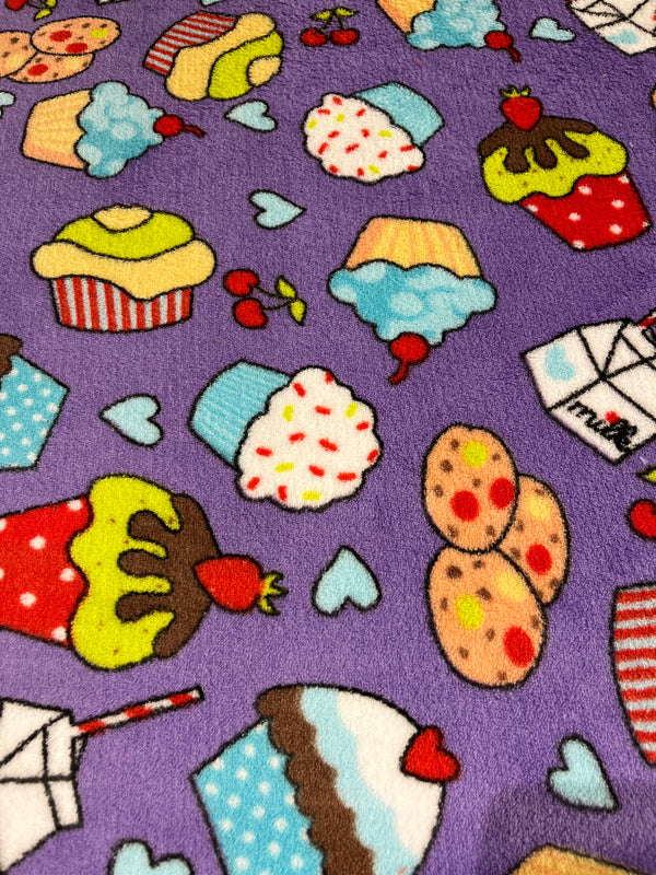 Cupcakes galore whisper fleece.  Brightly colored cupcakes on purple background.   100% polyester, 60” wide and $9.99 per yd