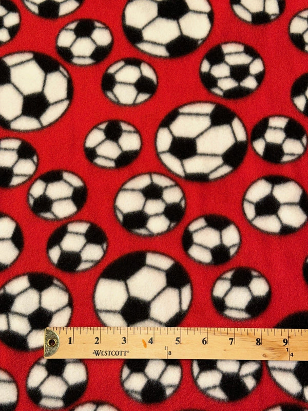 Soccer Balls on Red Fleece - 58/60" Wide